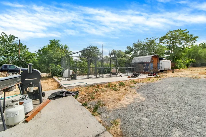 Expansive gravel area alongside a concrete patio