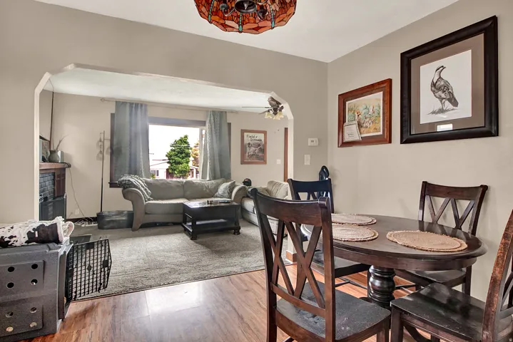 Dining area featuring wood-finish flooring and a distinctive stained-glass ceiling fixture