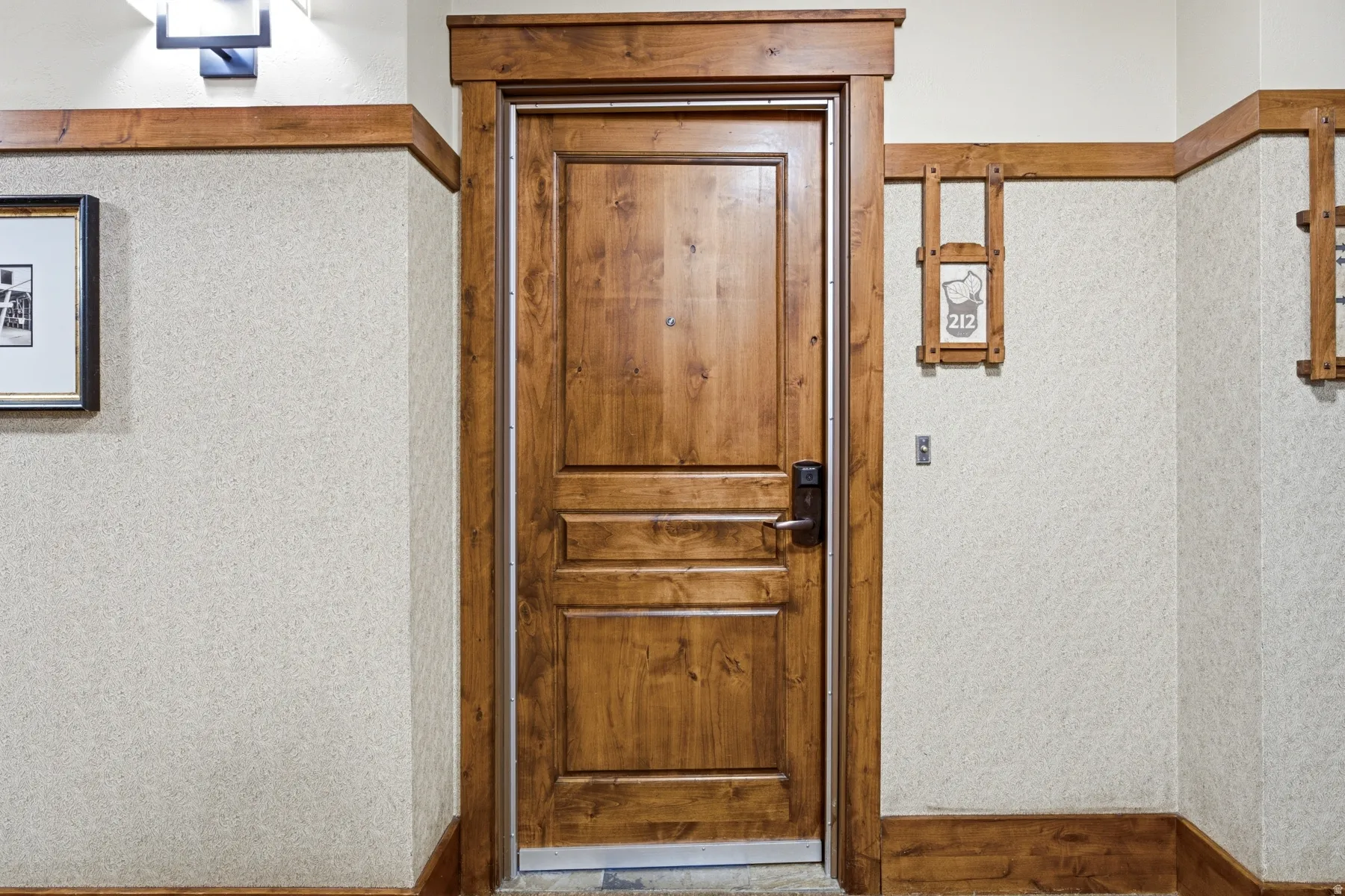 Solid wood entry door with panel detailing and a digital lock