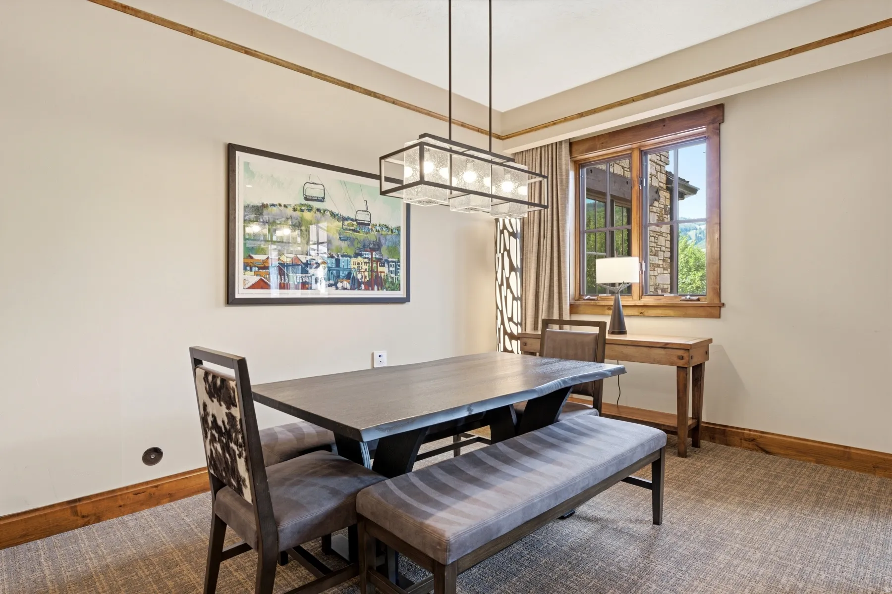 Dining area featuring wood-finish trim, a rectangular chandelier, and a large window with wood framing