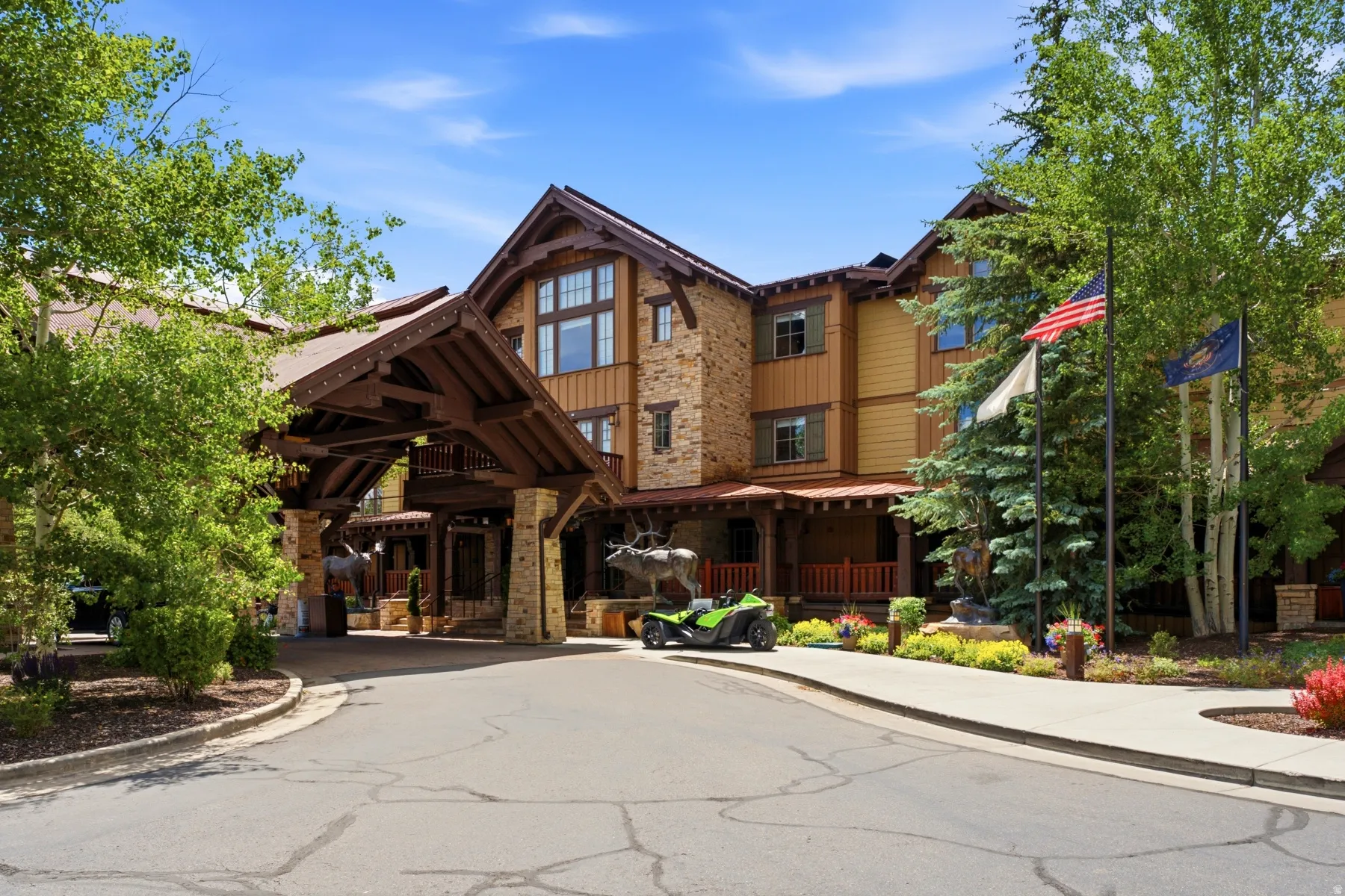 Rustic-inspired architecture featuring a grand portico entry with exposed timber framing