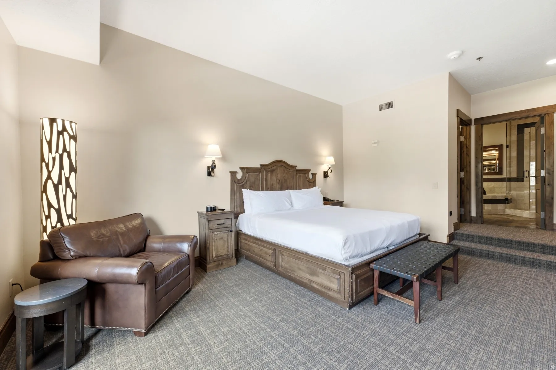 Spacious room featuring a vaulted ceiling and textured carpet flooring