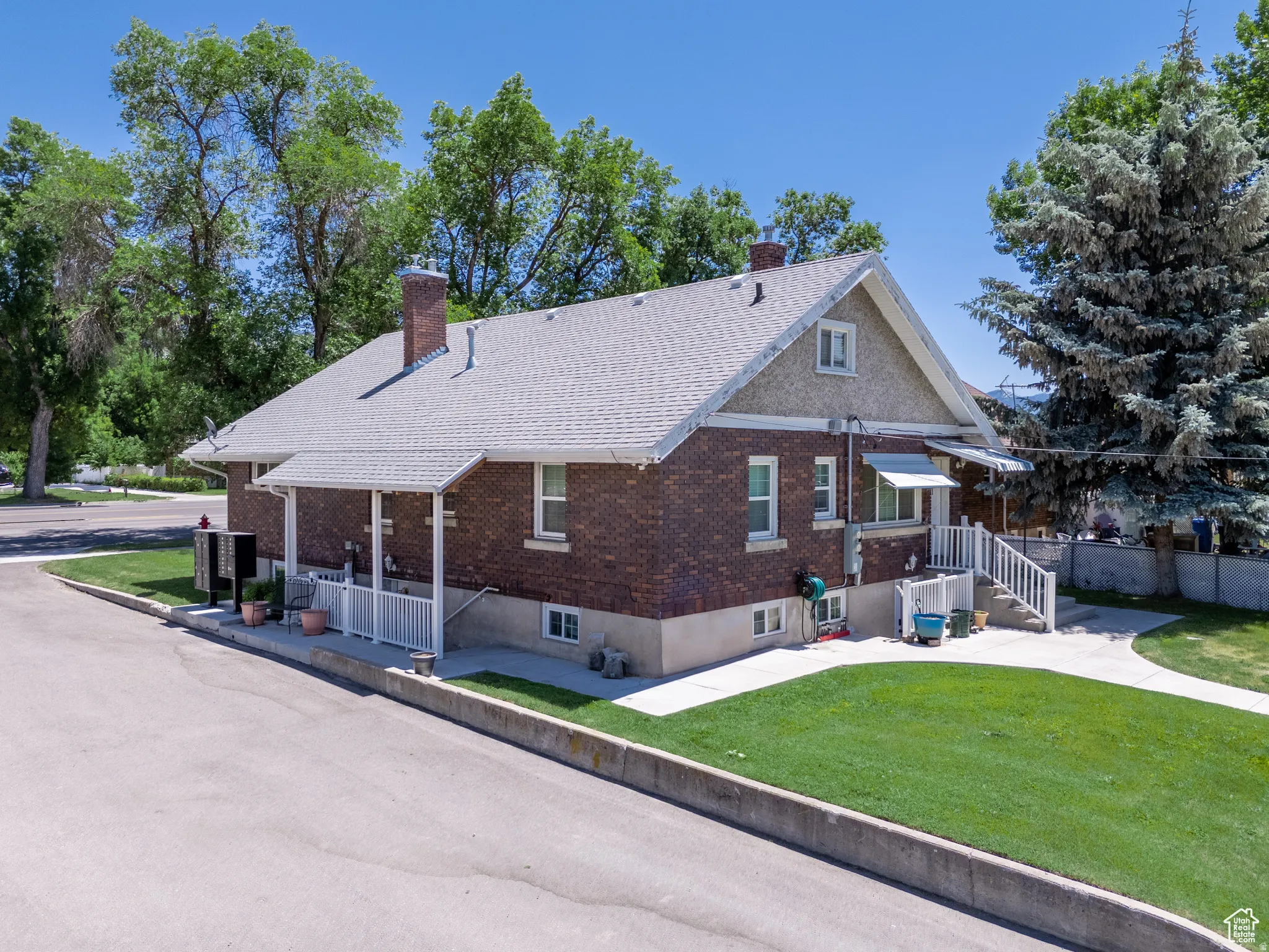 Brick exterior with a gabled roofline and textured stucco accents