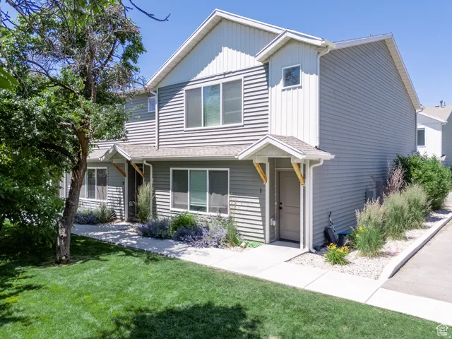 Two-story property featuring horizontal siding and white trim