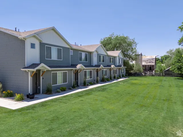 Townhome exteriors featuring light gray siding and white trim