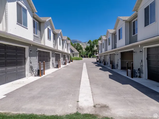 Series of two-story townhomes featuring horizontal siding and dark panel garage doors