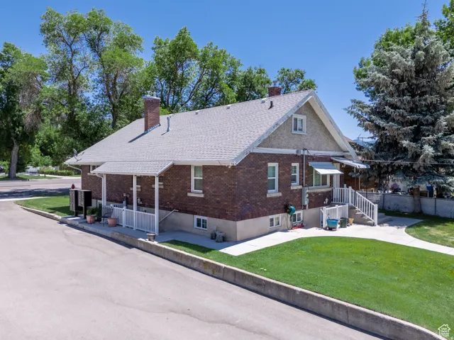 Brick exterior with a gabled roofline and textured stucco accents