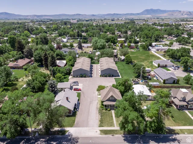 Aerial view featuring multiple residential structures and green spaces