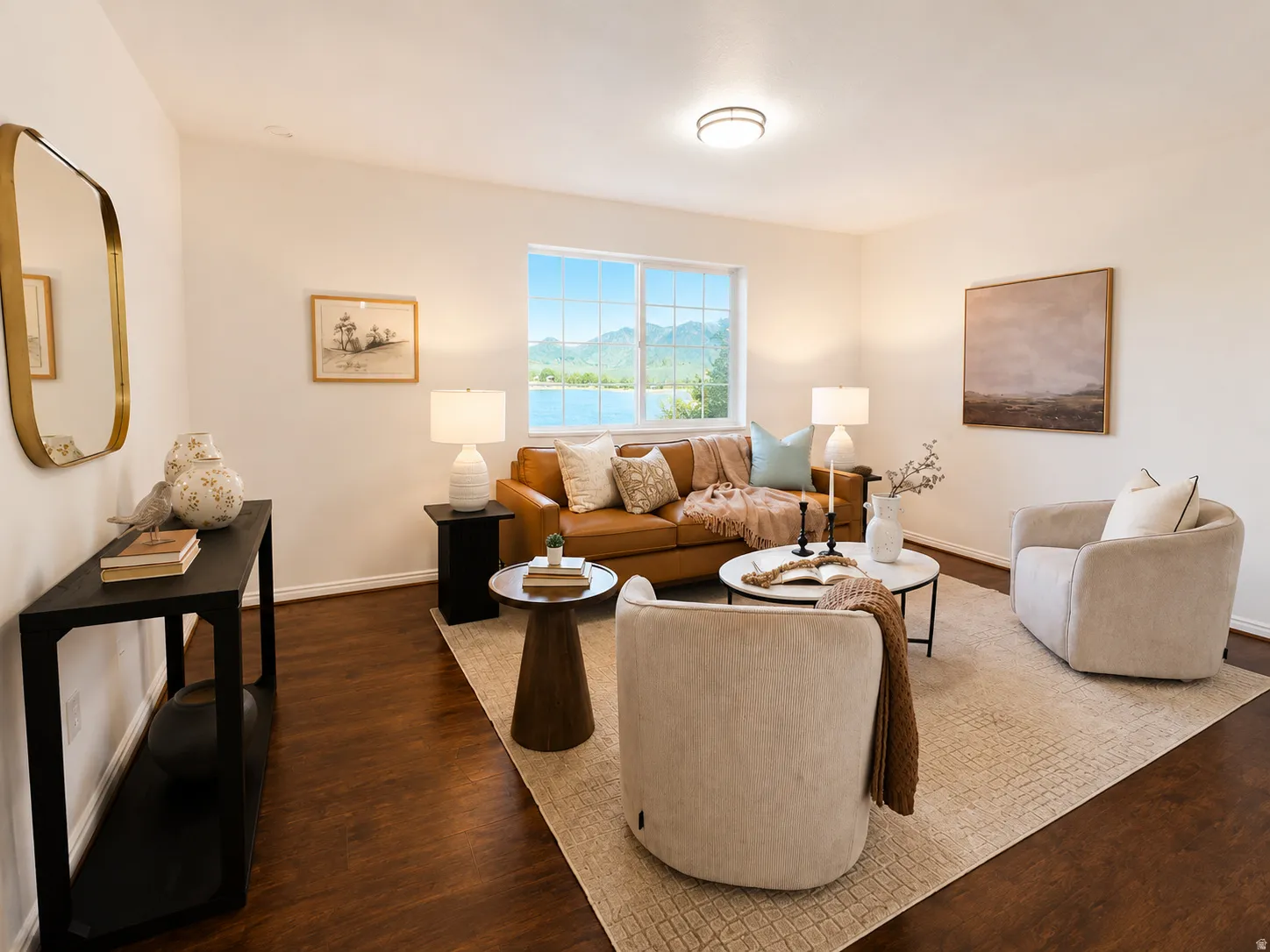 Hardwood-finish flooring throughout the room with white baseboards and neutral wall paint