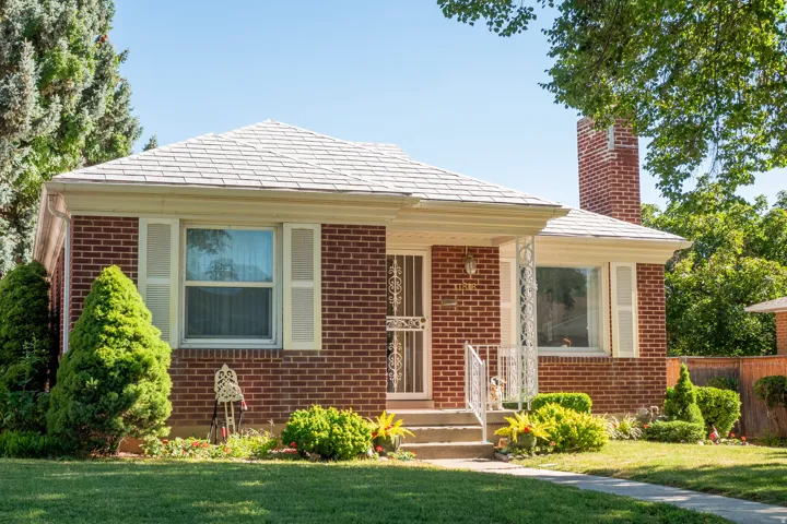 Red brick exterior with white trim and a gabled roof
