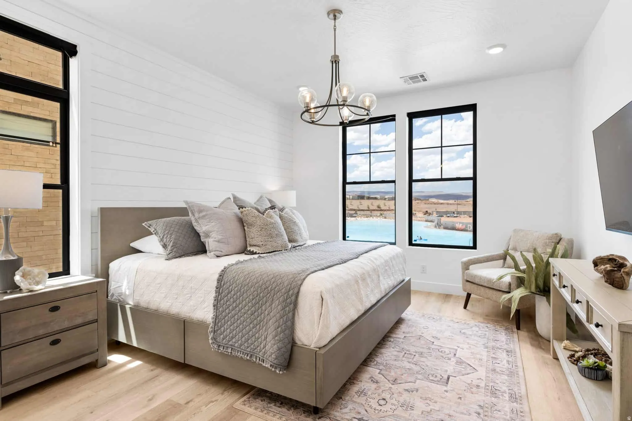 Bedroom featuring light wood-finish flooring, white shiplap accent wall, and recessed lighting