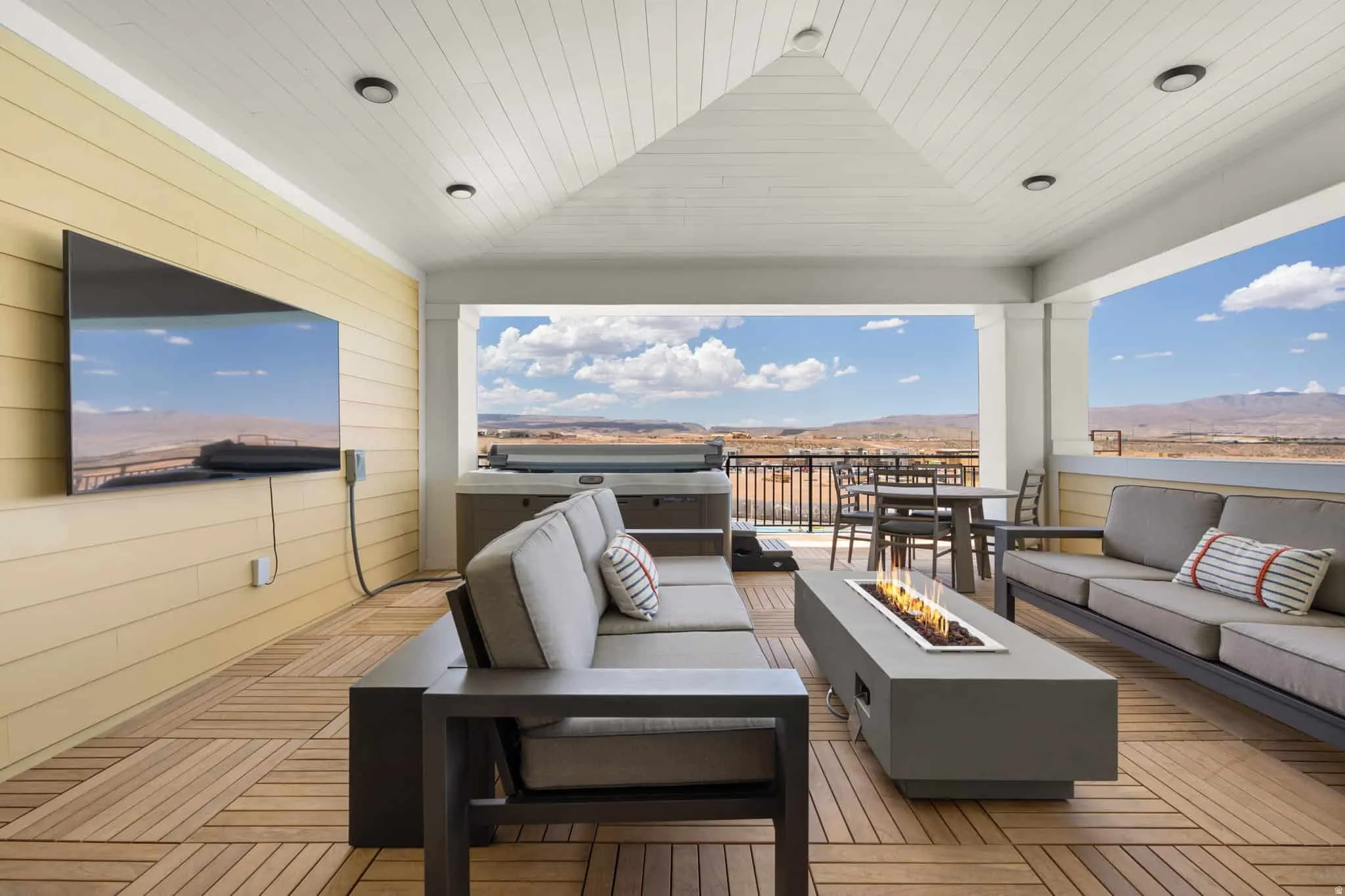Covered outdoor patio featuring wood-finish flooring, a vaulted plank ceiling, recessed lighting, and a fire pit