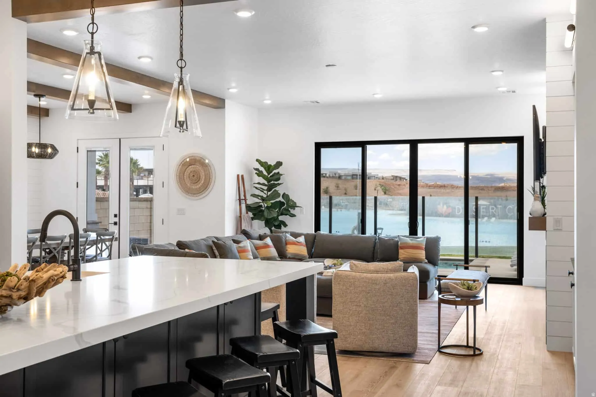 Open-concept living space featuring wood-finish flooring and extensive natural light