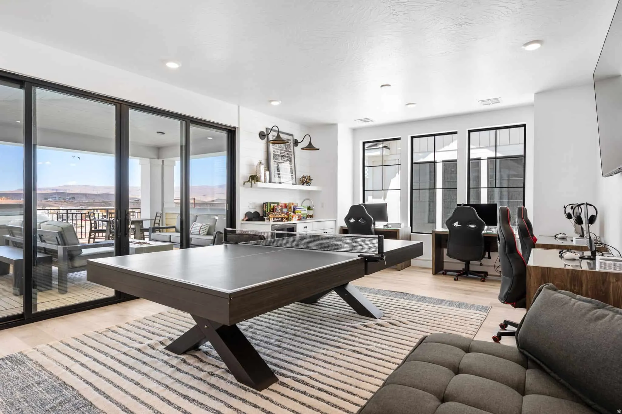 Spacious interior room featuring multiple built-in workstations and light wood-finish flooring