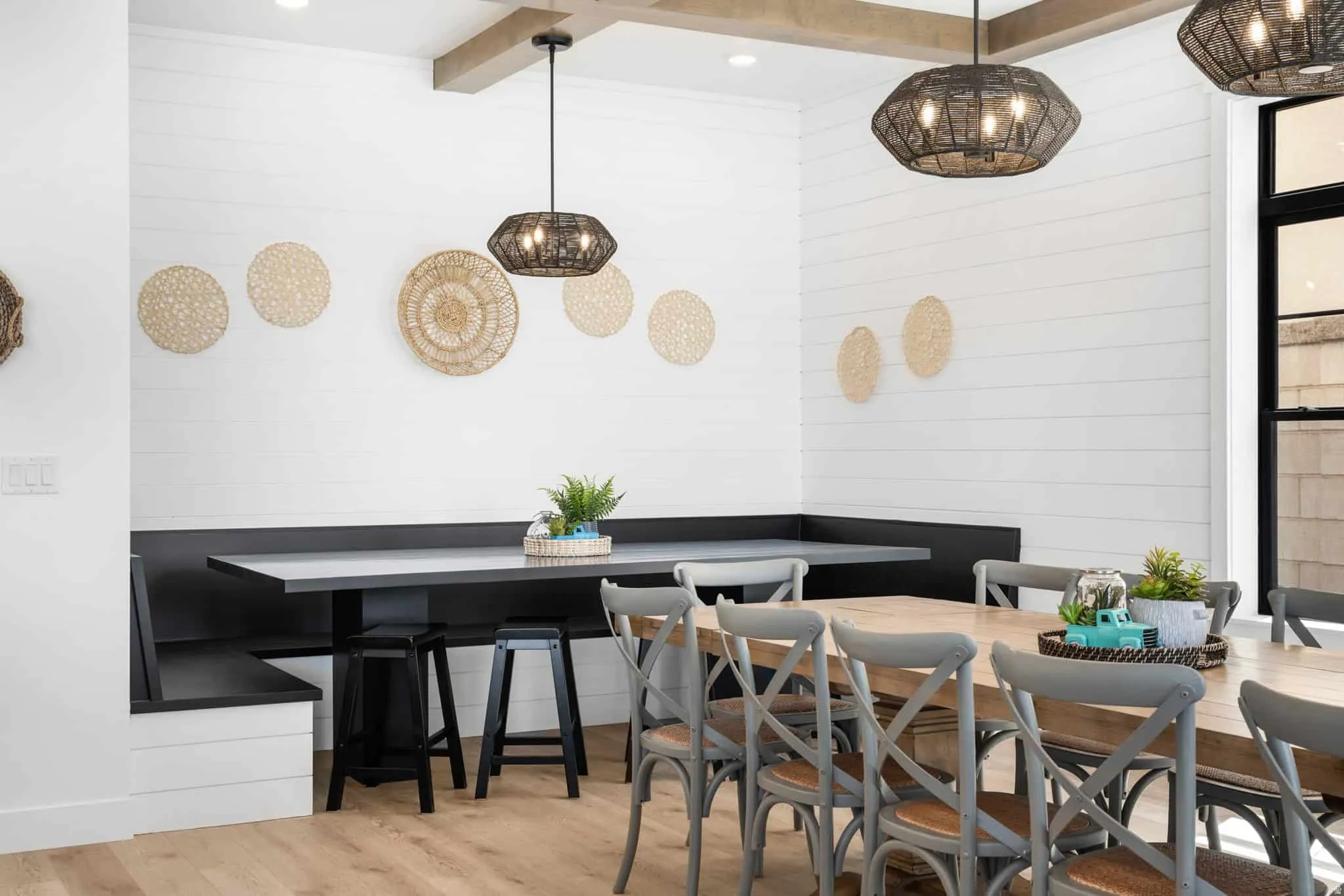 Dining area featuring wood-finish flooring and shiplap walls