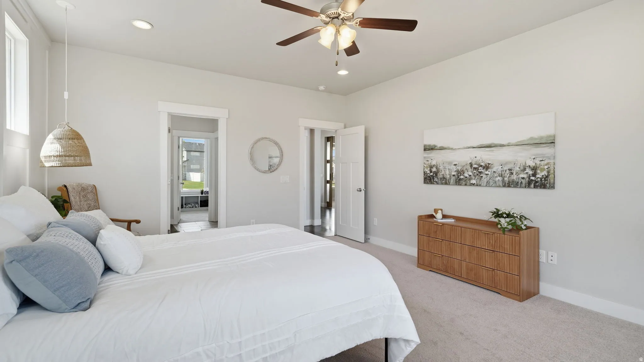 Spacious room with light neutral wall tones, recessed lighting, and a ceiling fan