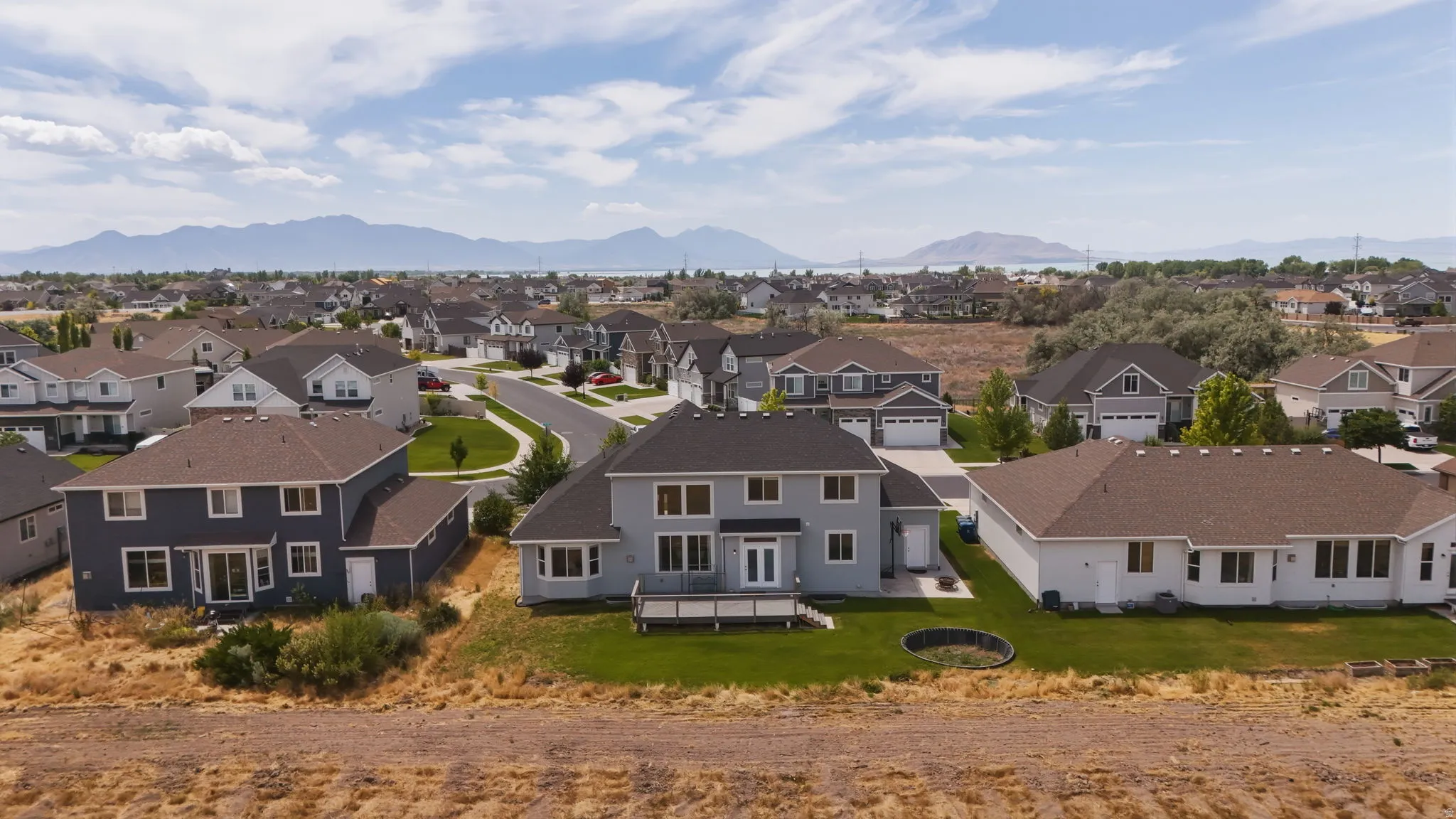 Aerial perspective showcasing residential properties with a mountainous backdrop