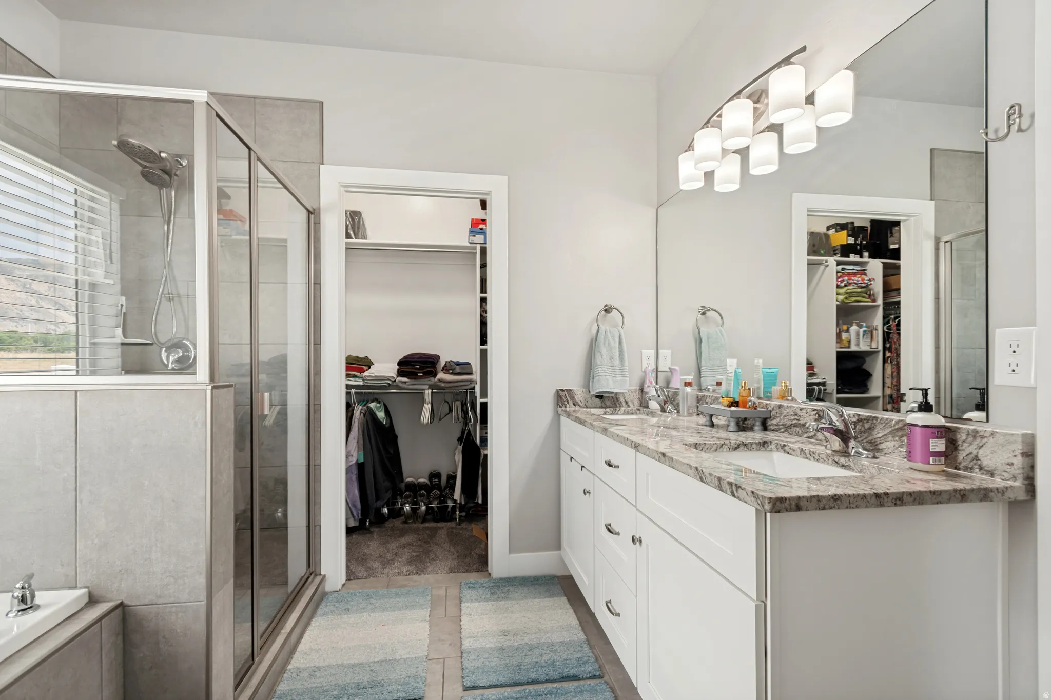 Double vanity with stone countertop and undermount sinks