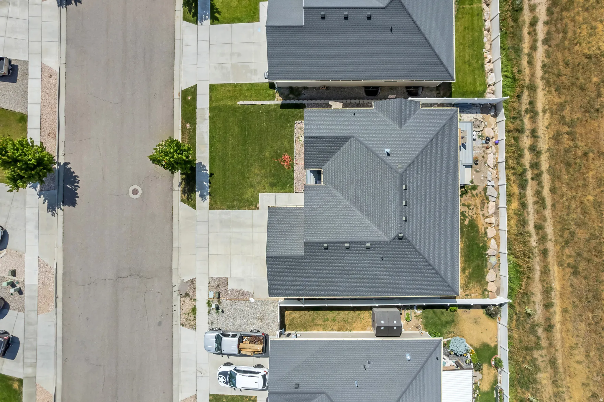 Aerial perspective featuring a property with a multi-gabled roofline and an adjacent manicured lawn
