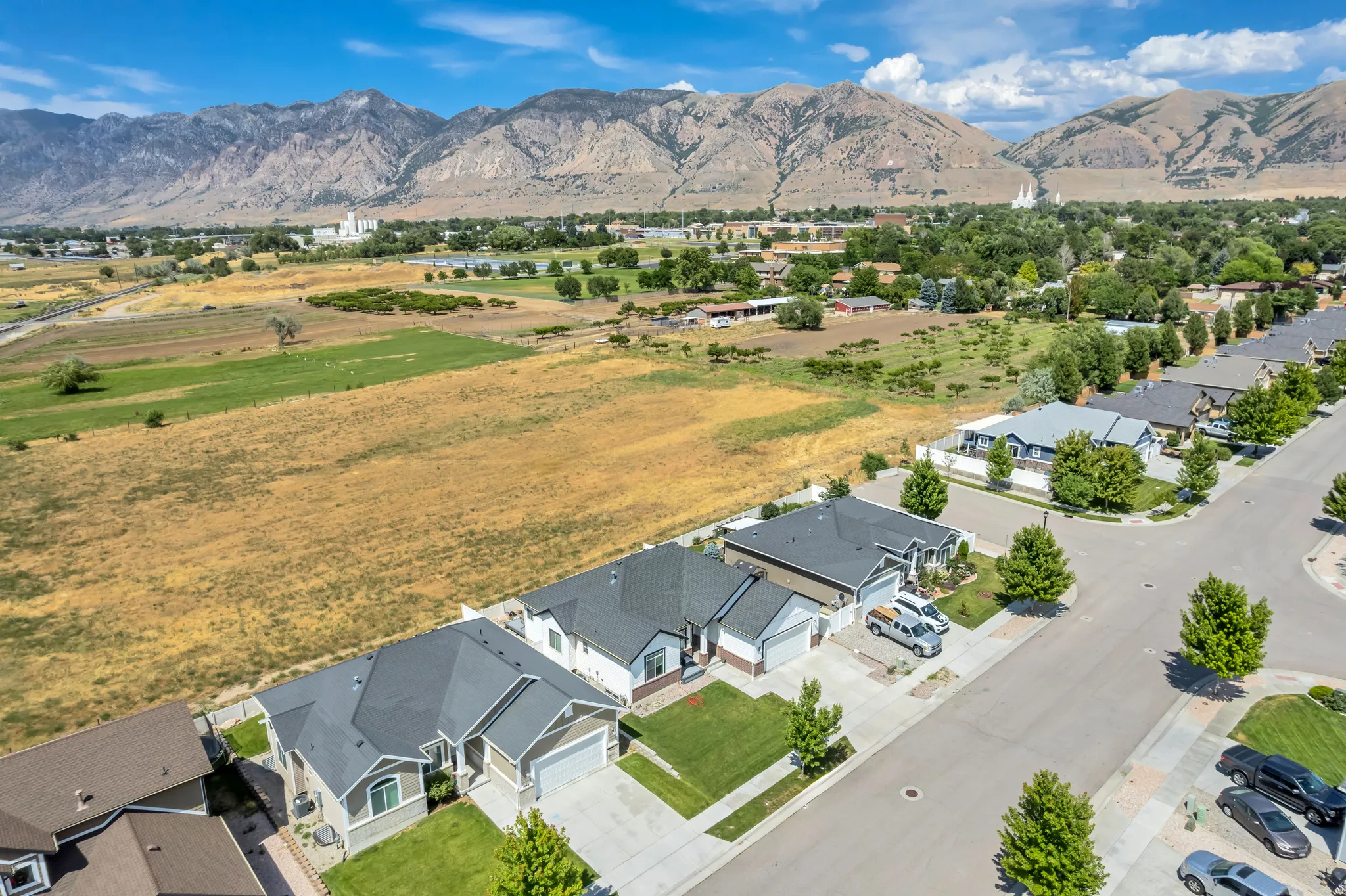 Residential street lined with single-family homes, each featuring a two-car garage