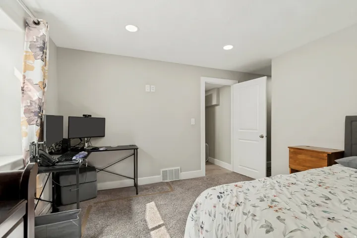Room with light gray walls and recessed ceiling lighting