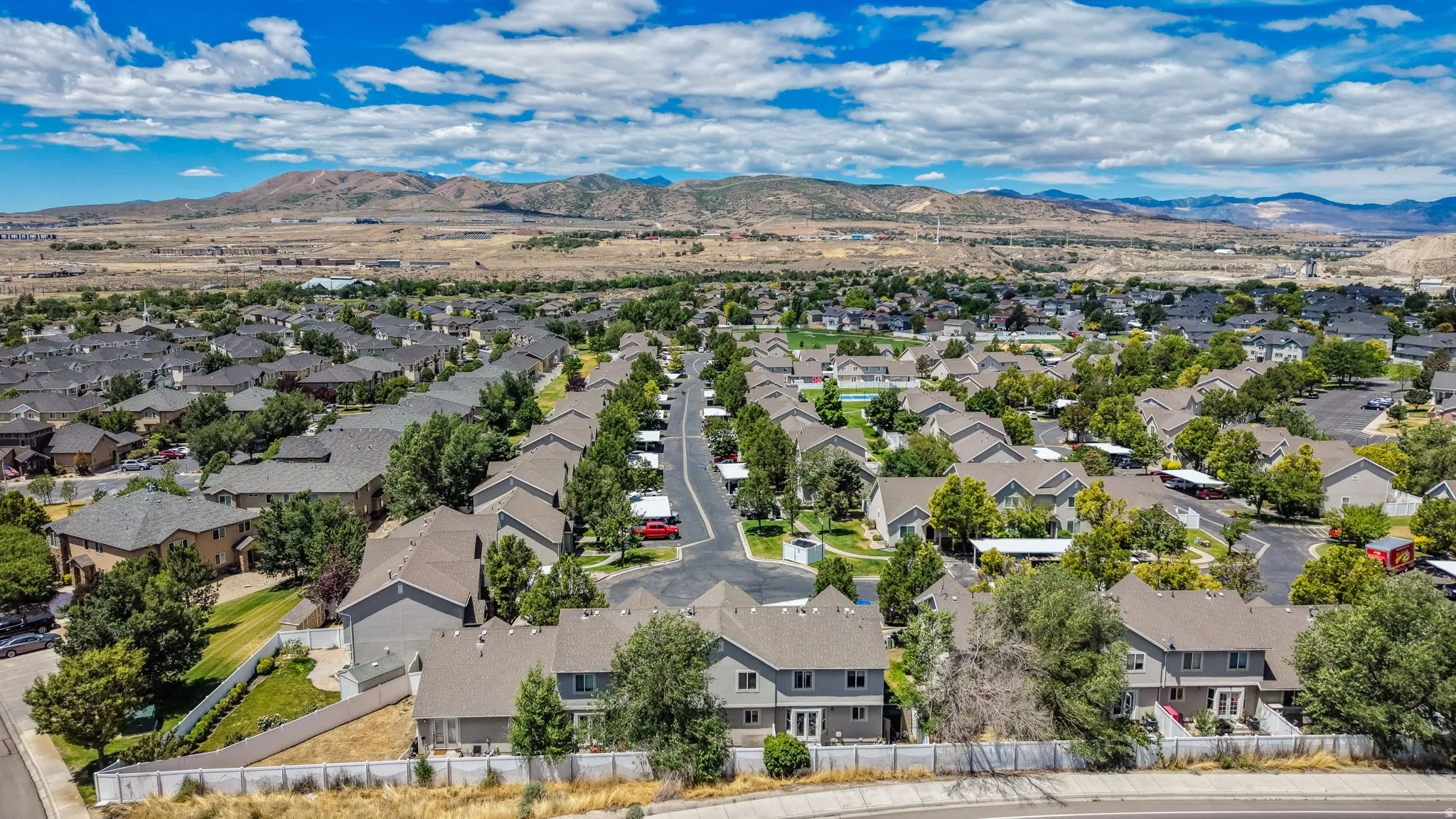 Expansive residential community featuring numerous homes with pitched roofs and established trees