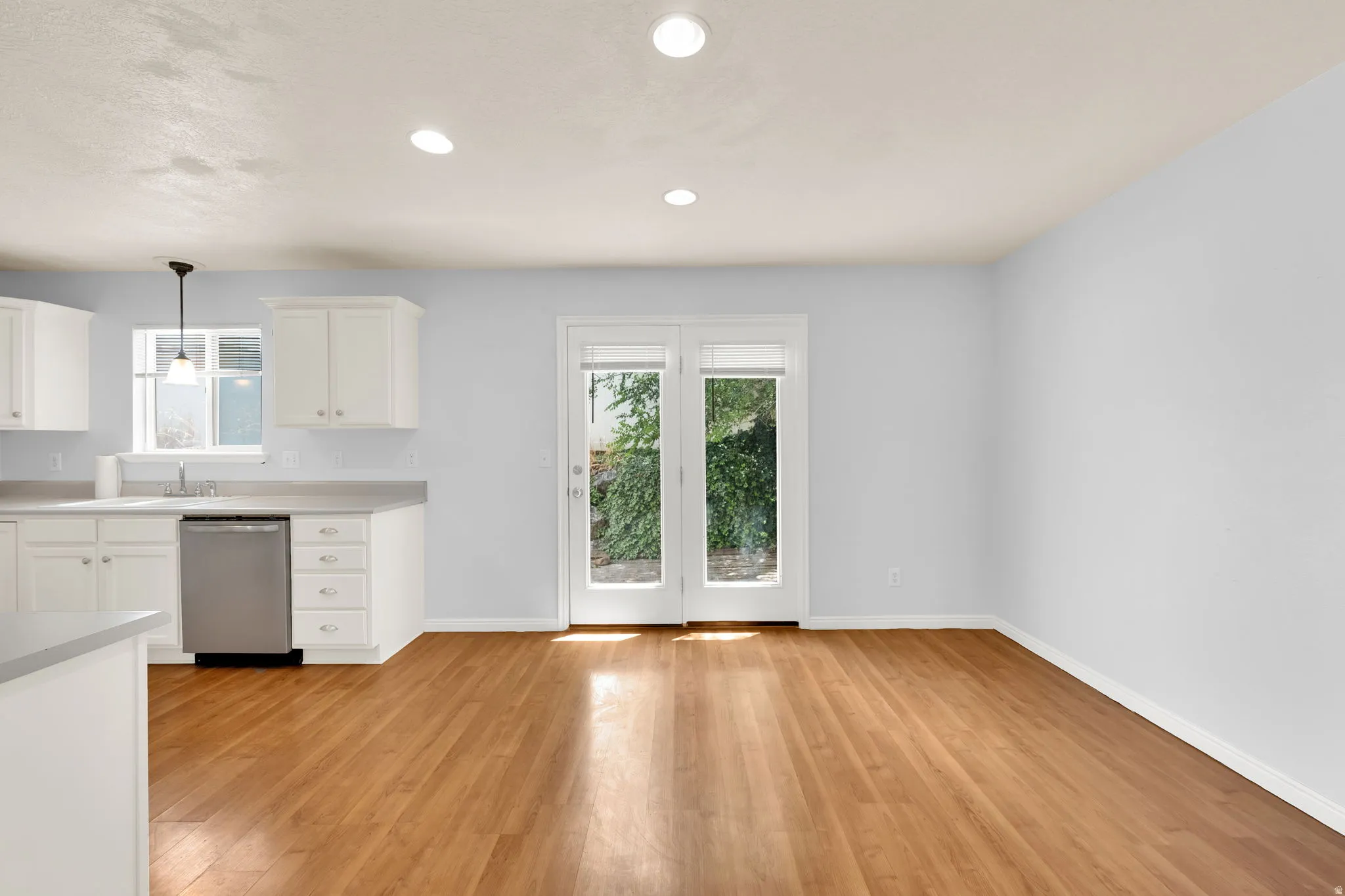 Open concept living space featuring wood-finish flooring and recessed lighting