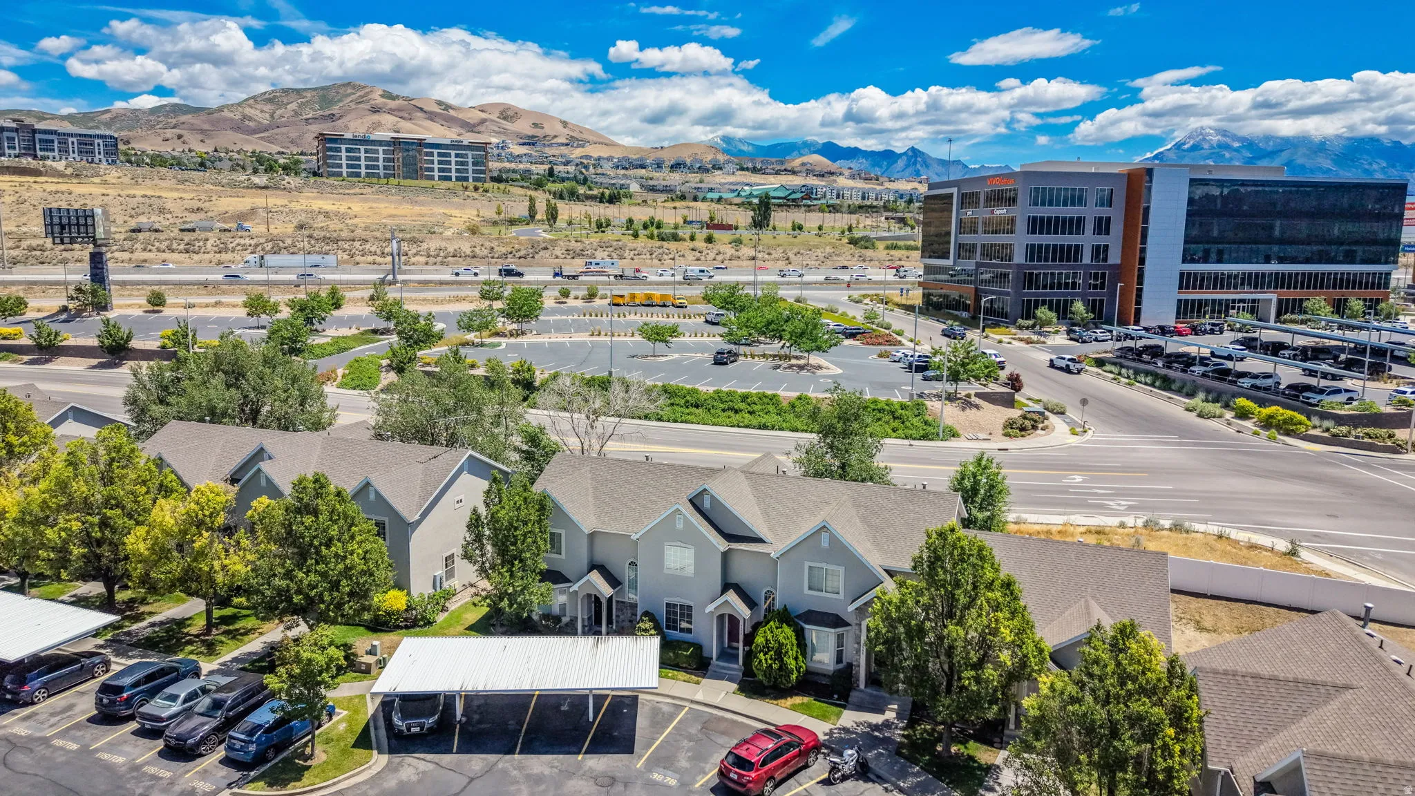 Residential structures with pitched roofs and light gray siding