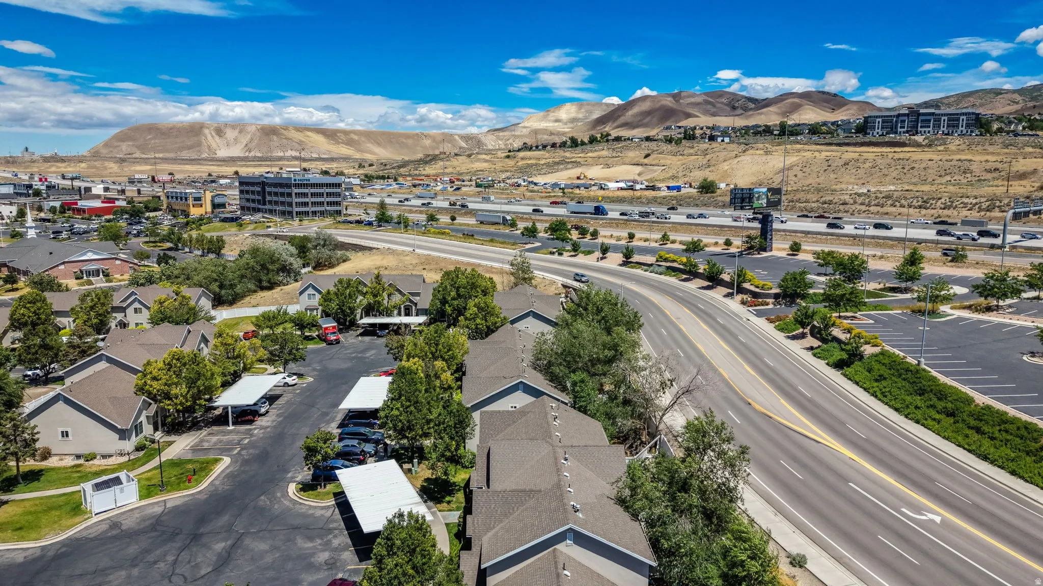 Aerial perspective showcasing a residential development with multiple buildings featuring pitched roofs