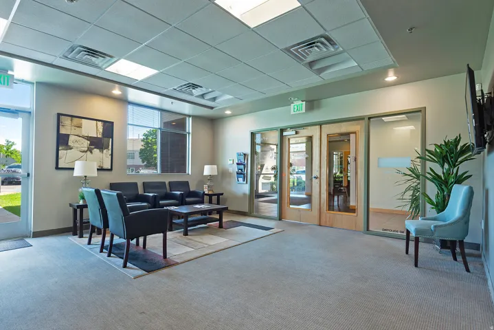 Carpeted common area featuring multiple seating options