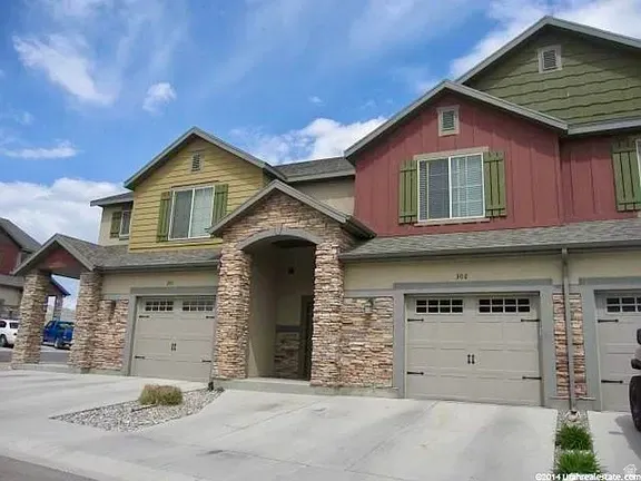 Multi-story exterior with varied siding, stone accents, and a covered entry