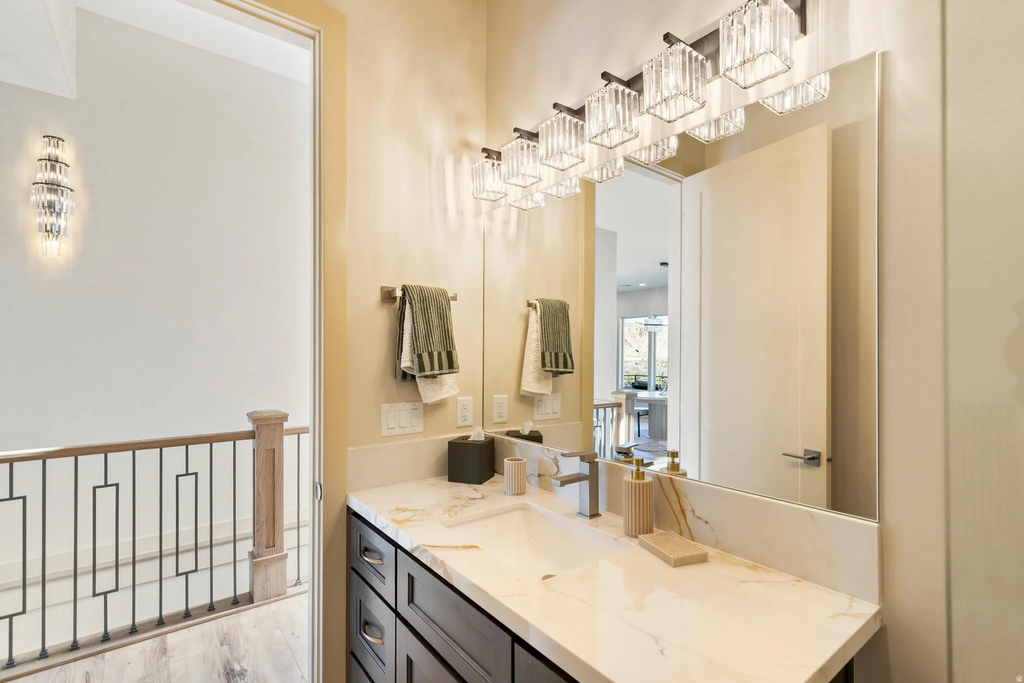 Vanity with a light-toned countertop, integrated rectangular sink, and polished chrome faucet