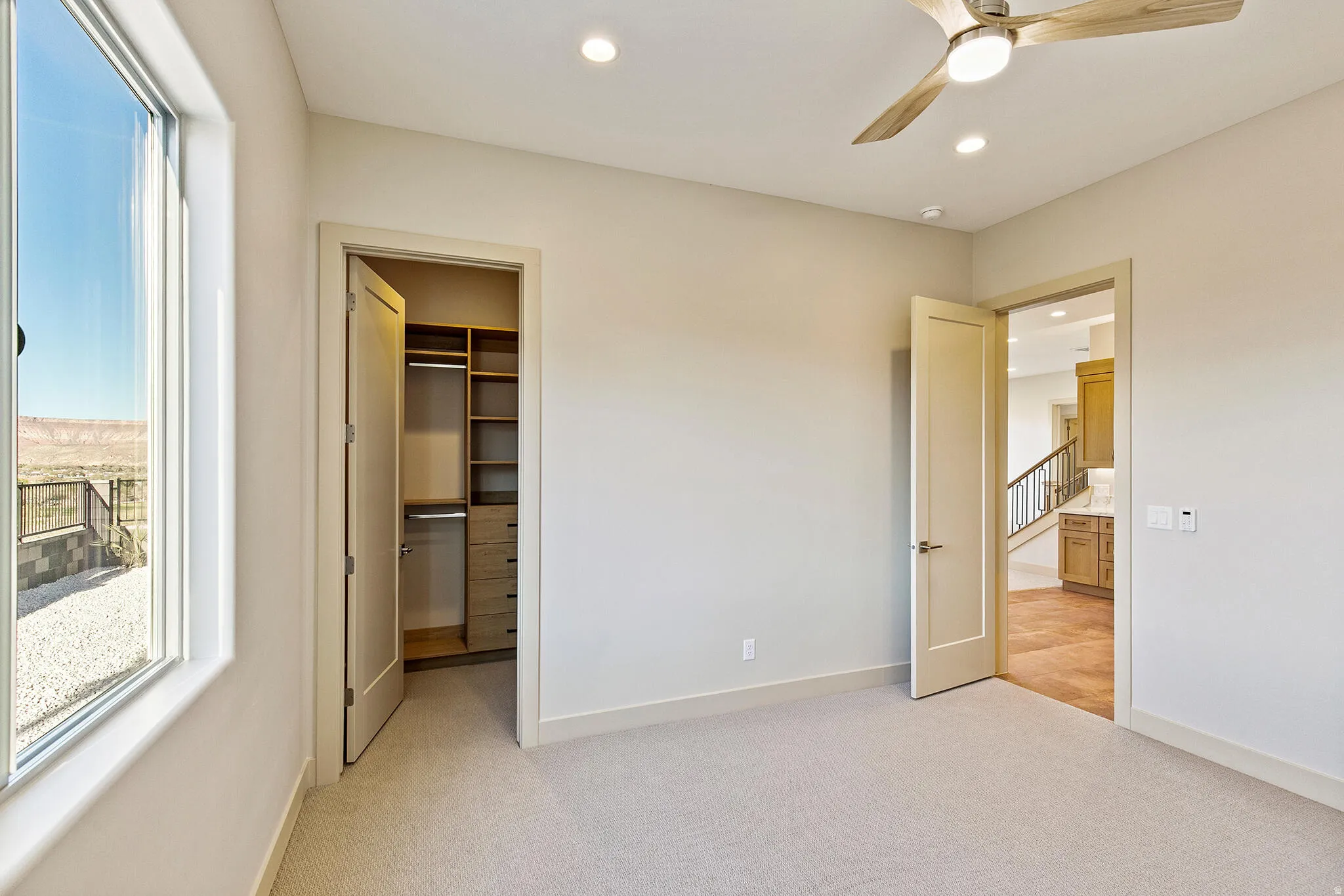 Spacious room with light-toned carpeting and neutral wall tones