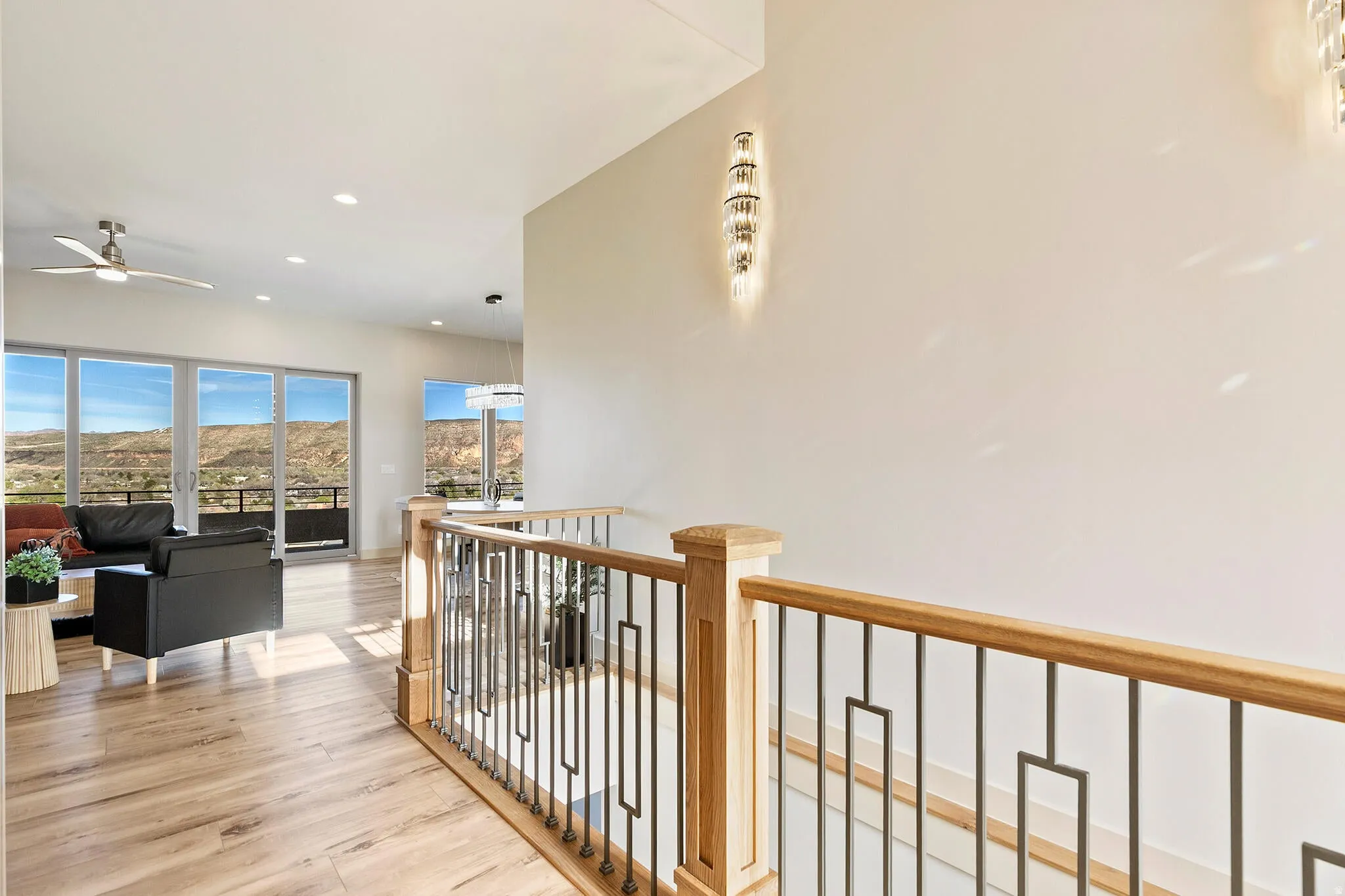 Upper-level landing featuring a wood and metal railing system