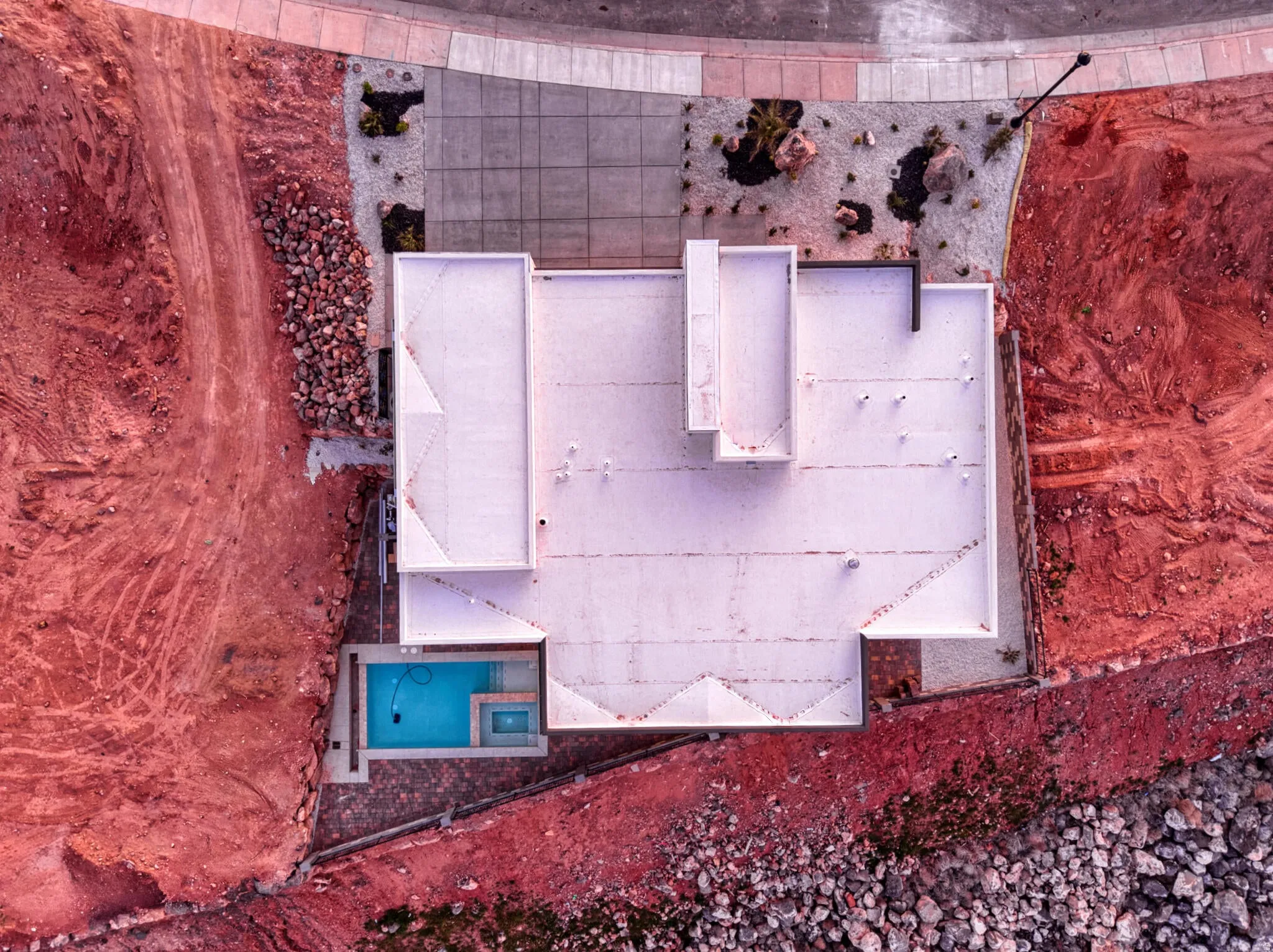 Single-story property with a flat roofline and a private, rectangular swimming pool