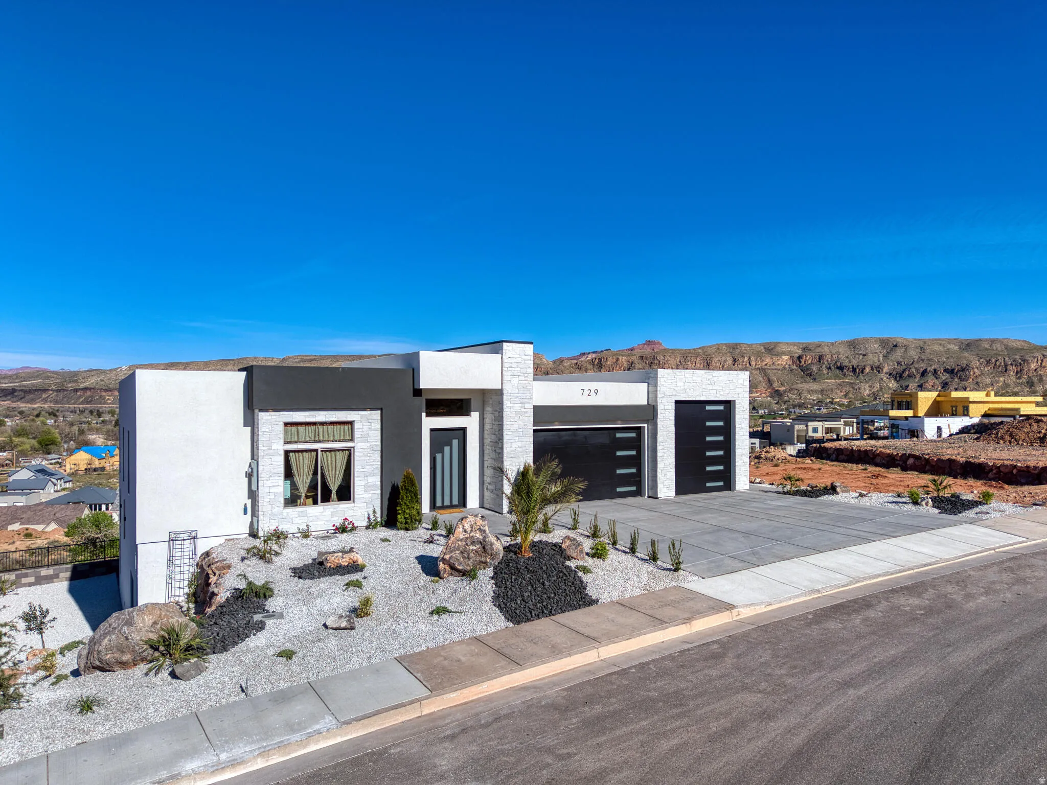 Modern facade featuring white stucco and stone accents