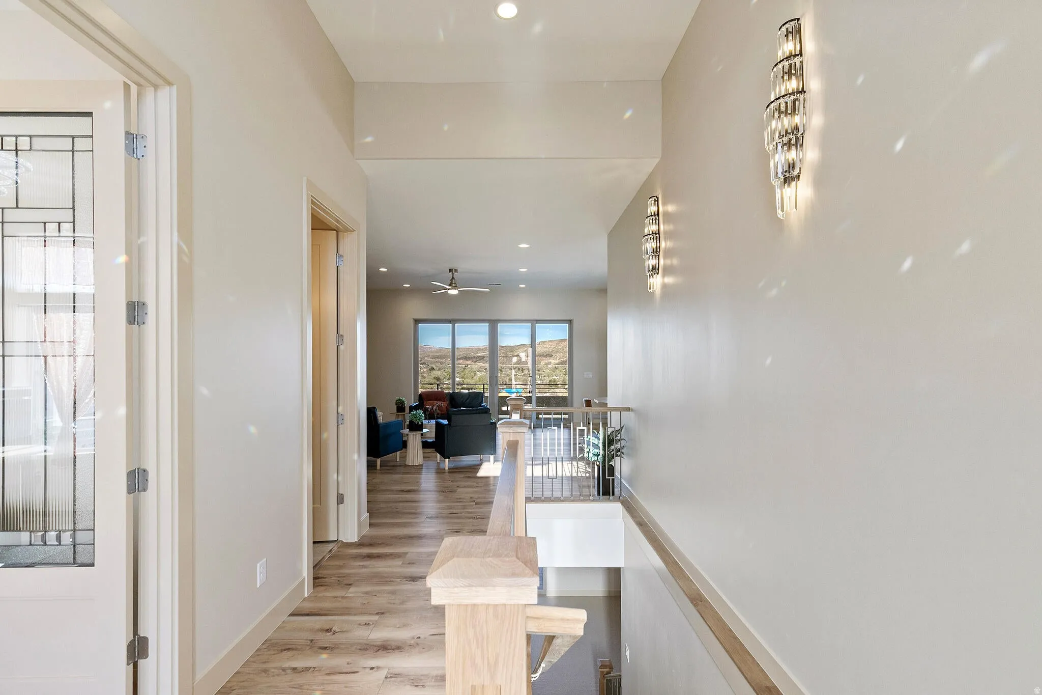 Hallway featuring wood-finish flooring, recessed lighting, and modern wall sconces