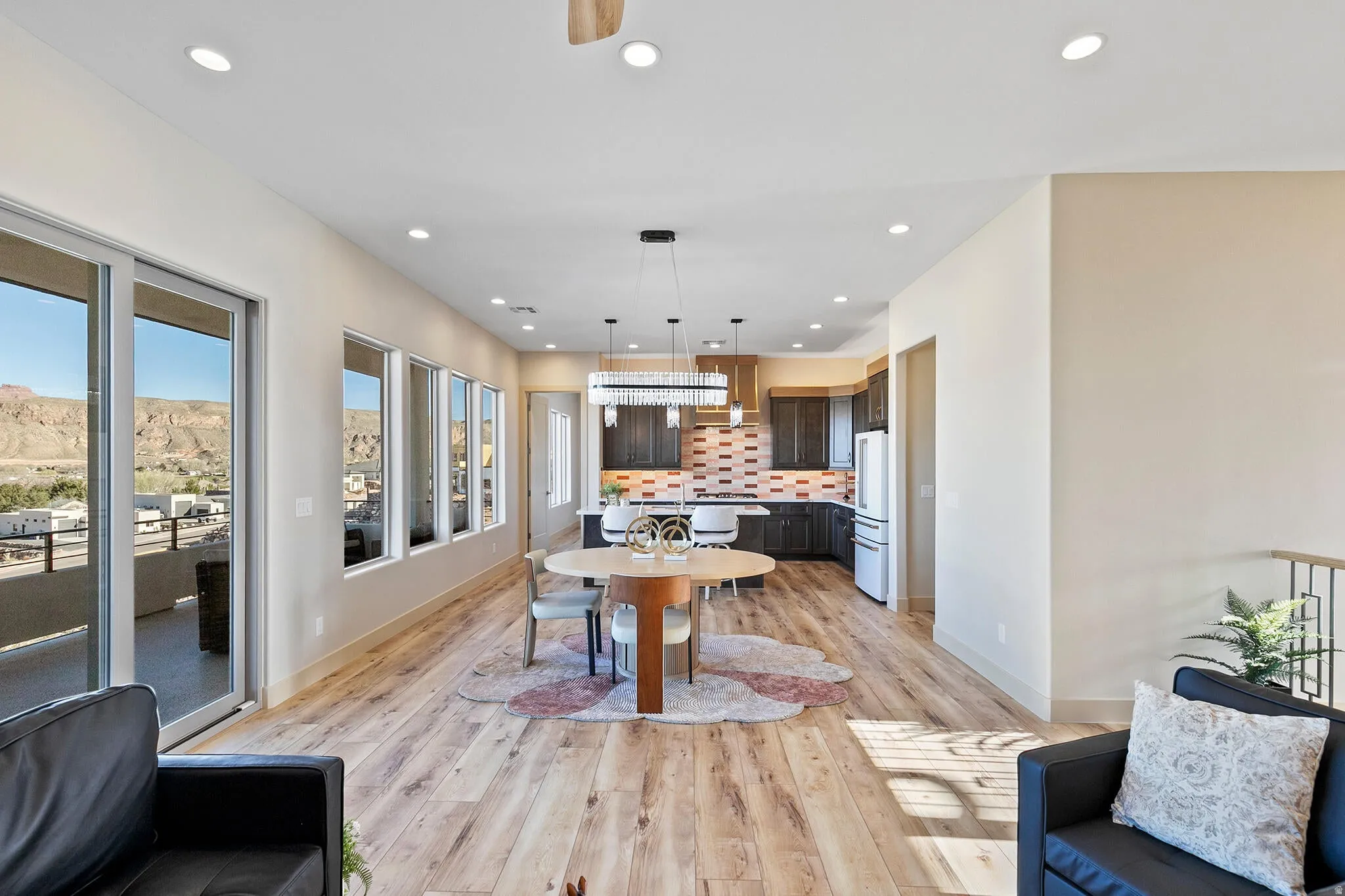 Open-concept living space with blonde wood-finish flooring