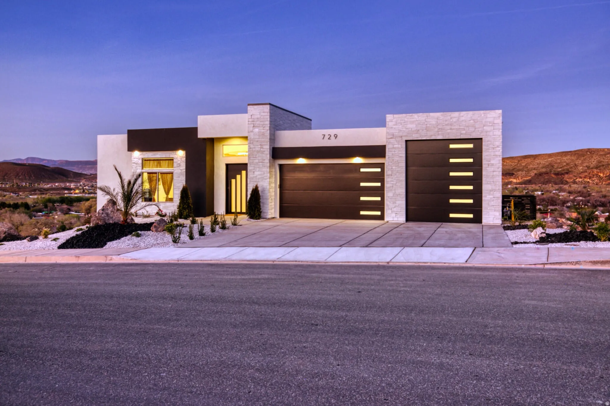 Contemporary stucco exterior with dark accents and stone-clad features