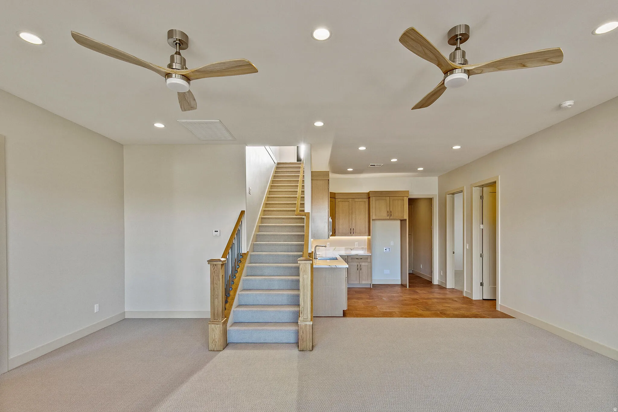 Open-concept living space featuring recessed lighting and two ceiling fans with integrated lighting