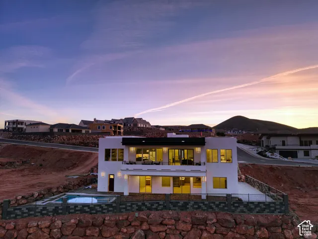 Contemporary multi-level residence featuring a white stucco exterior and black trim