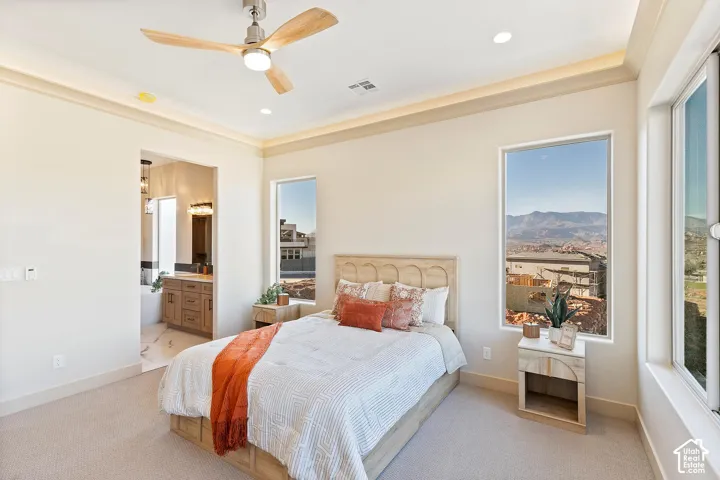 Well-appointed bedroom featuring a ceiling fan with integrated lighting, recessed ceiling lighting, and crown molding