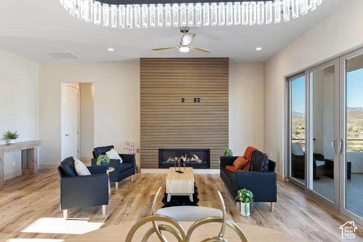 Spacious living area featuring wood-finish flooring and an accent wall with a built-in fireplace