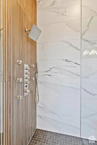 Contemporary shower enclosure featuring a wood-finish slat wall, square rainfall shower head, and an integrated multi-function shower panel with controls