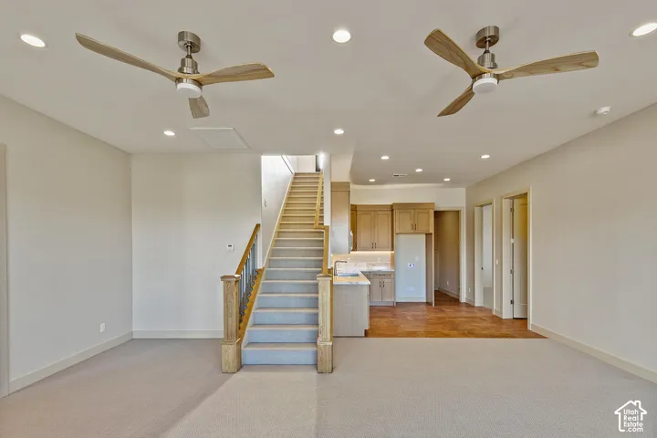 Open-concept living space featuring recessed lighting and two ceiling fans with integrated lighting