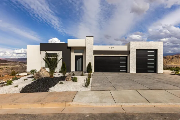 Modern exterior showcasing a multi-textured facade with white stone accents and dark contrasting panels