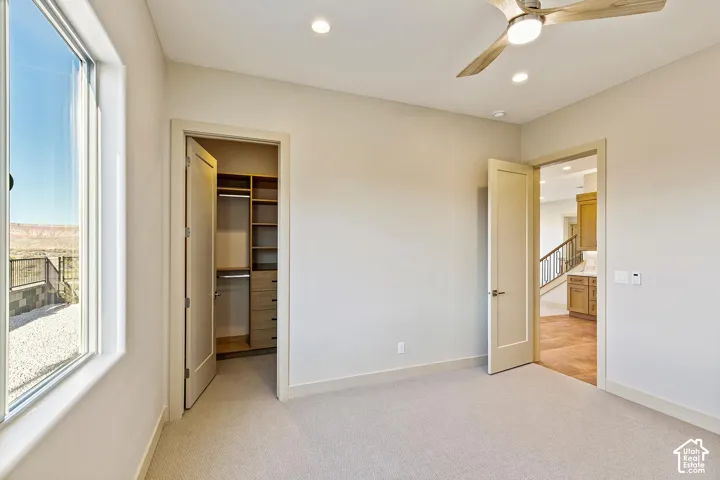 Spacious room with light-toned carpeting and neutral wall tones