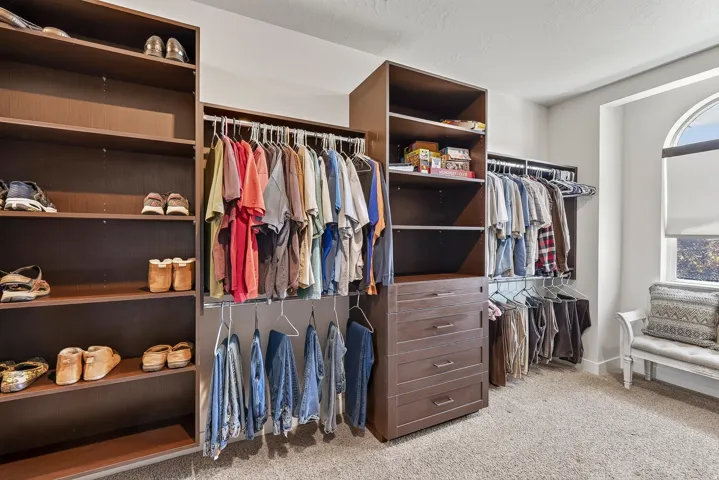 Custom closet system featuring built-in shelving, hanging rods, and integrated drawers