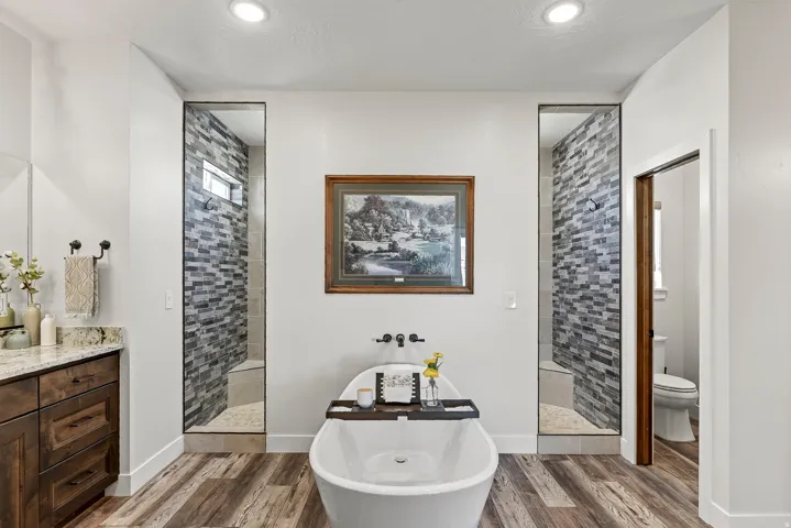 Freestanding soaking tub with wood-finish flooring