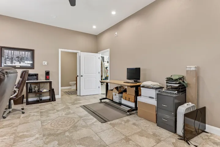 Spacious room with high ceilings, recessed lighting, and light-toned walls